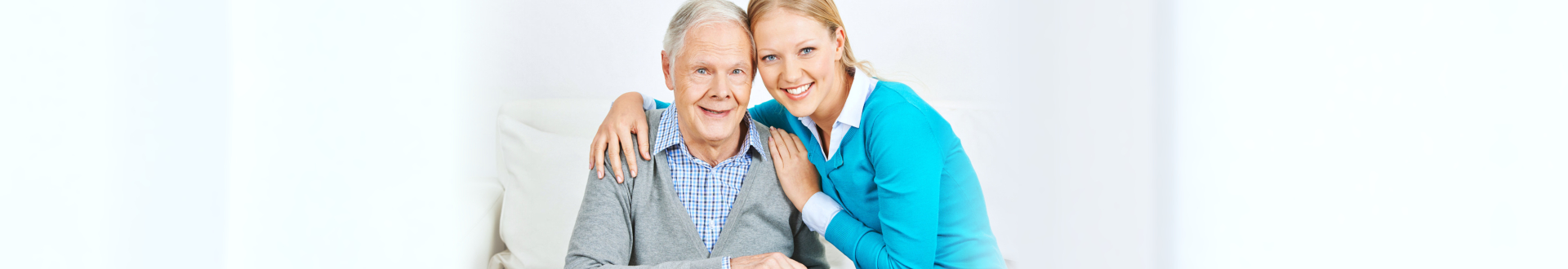 caregiver hugging senior man