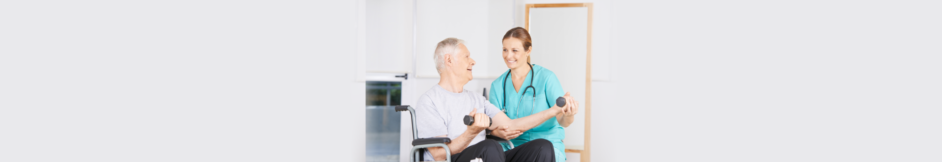 nurse helping senior man with his exercise